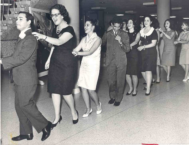 Students in a Conga line snake through Thompson Hall lobby